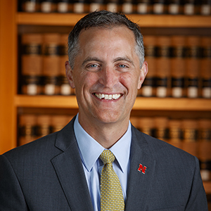 headshot of a smiling man